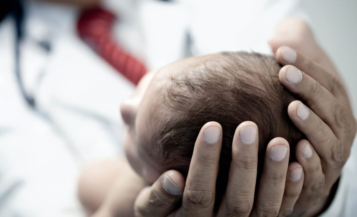 Pediatrician holding a newborn baby