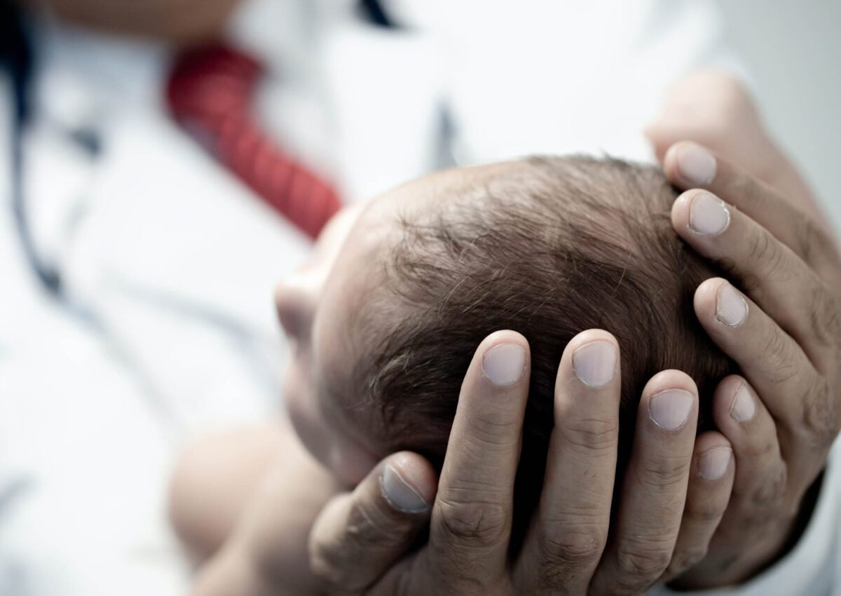 Pediatrician holding a newborn baby