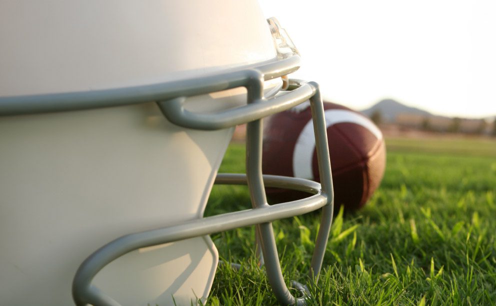 helmet and football on field